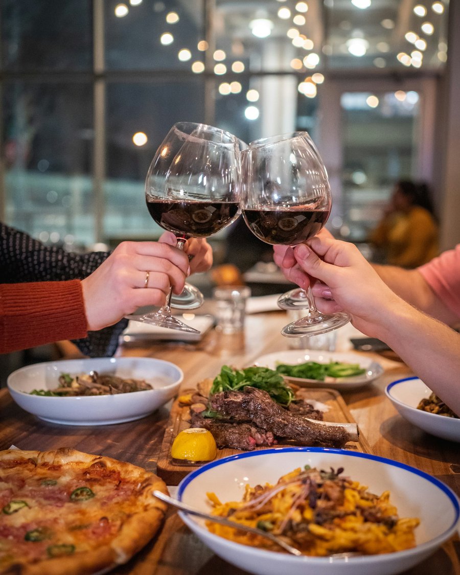 Friends raising glasses over dinner
