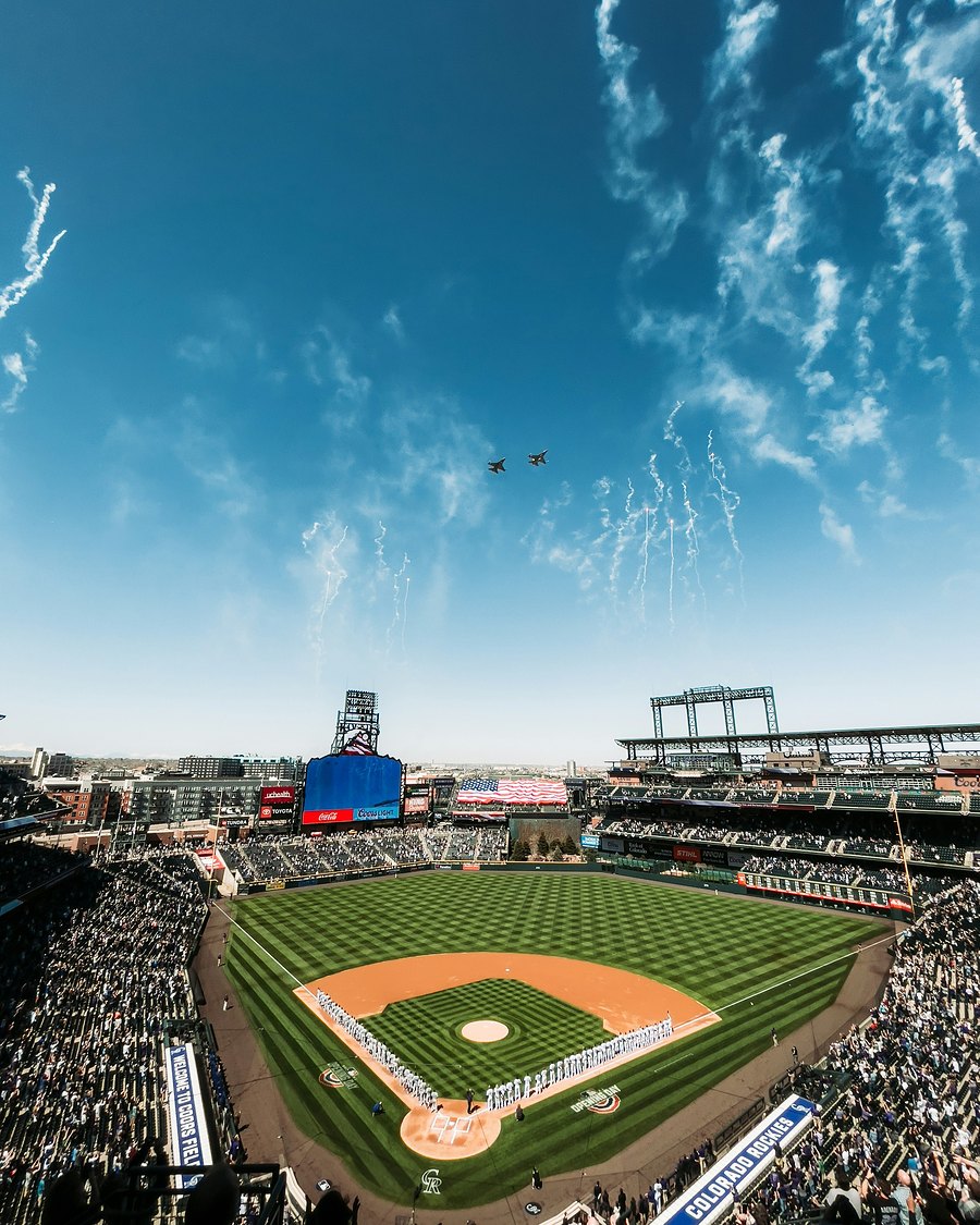 A baseball stadium under a bright blue sky